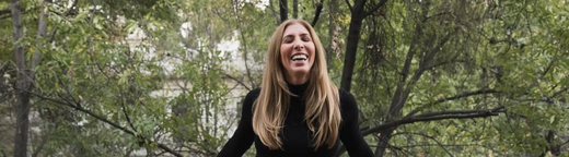 Ripley Rader smiling brightly, embodying free spirit and joy for life, showcasing her passion for purpose-driven fashion and making a difference.