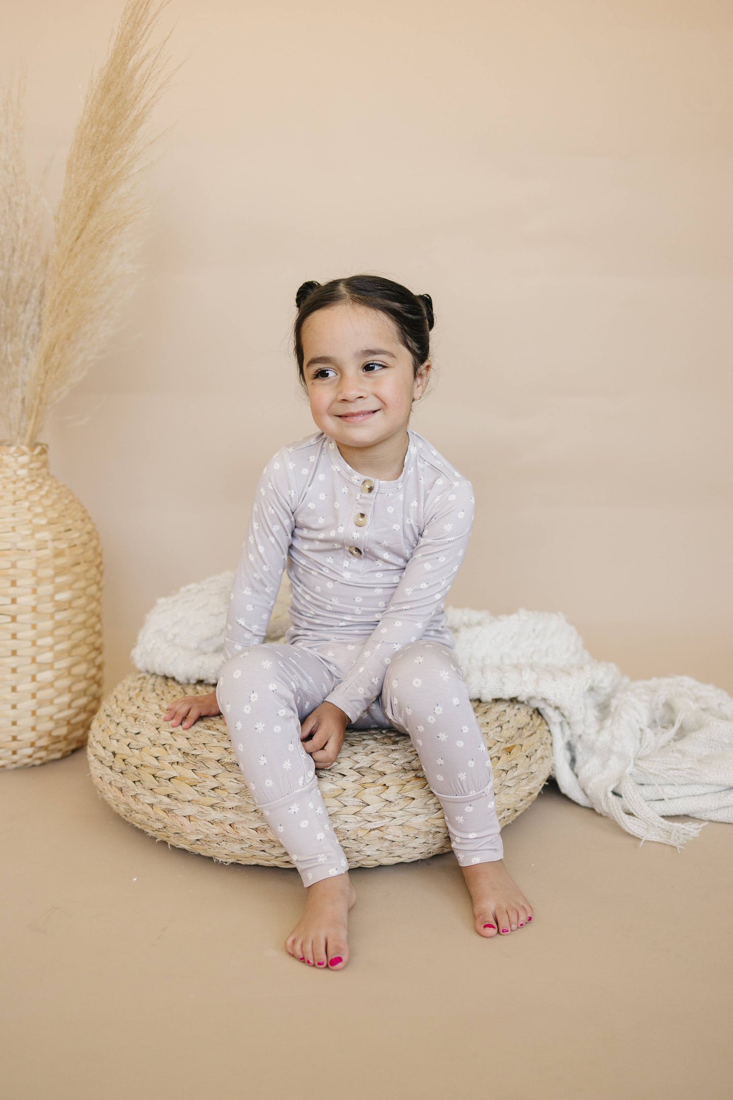 Daisy Floral 2pc Henley Bamboo Pajamas set laid flat, featuring a Henley top and matching floral pants.