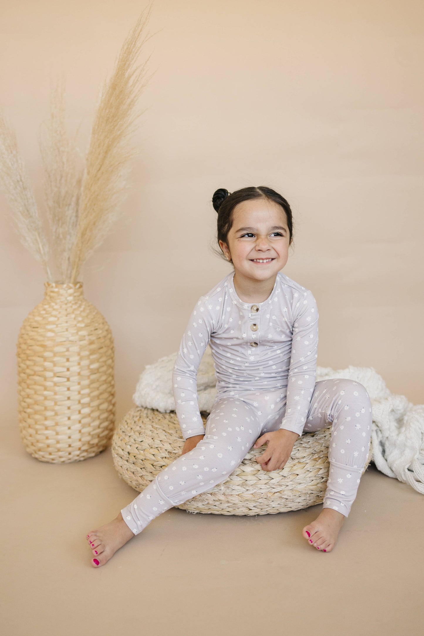 Happy toddler wearing the Daisy Floral 2pc Bamboo Pajamas, enjoying cozy comfort.