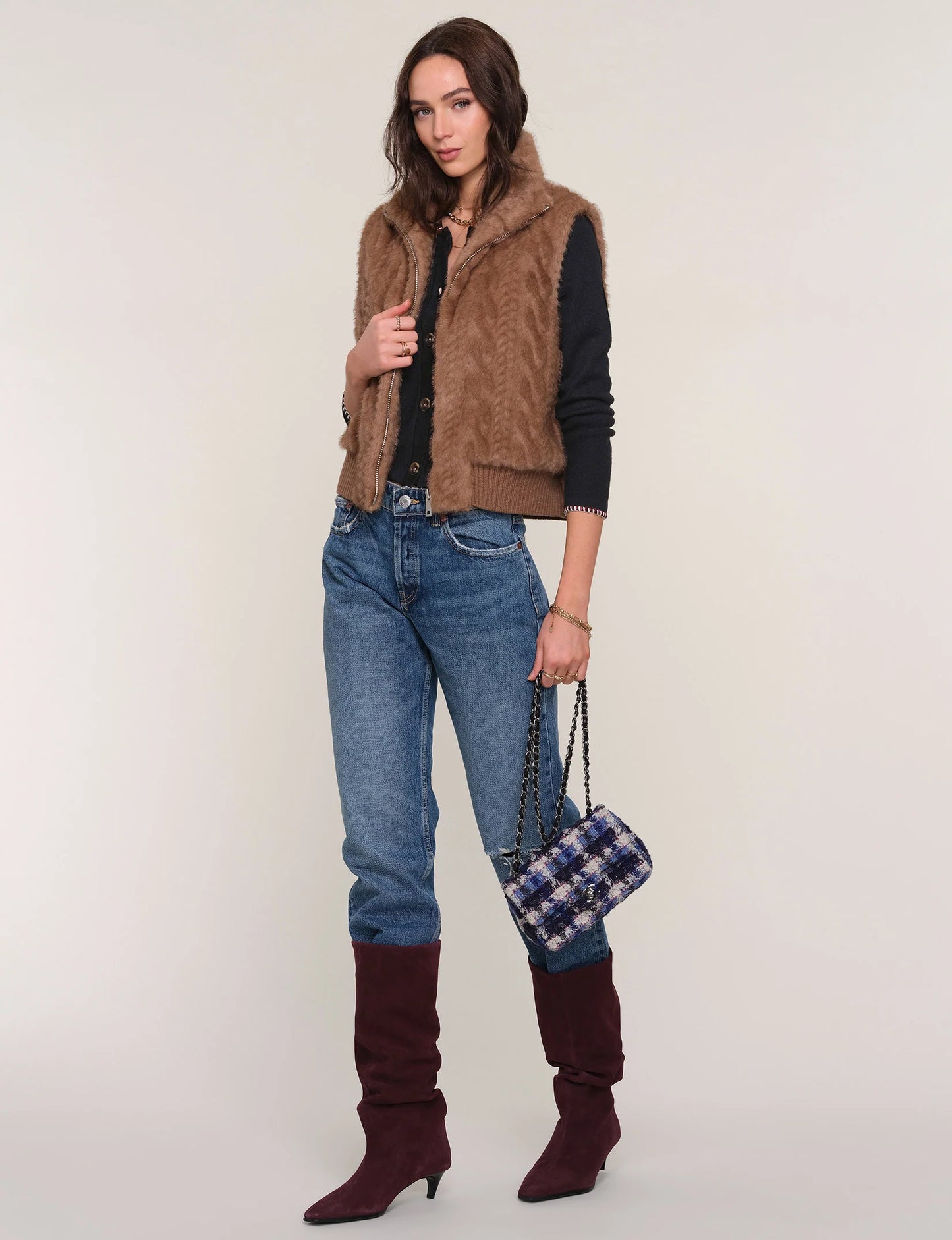 Full-length view of The Liana Vest on model paired with denim and tall boots, showcasing complete outfit and cozy outerwear style.