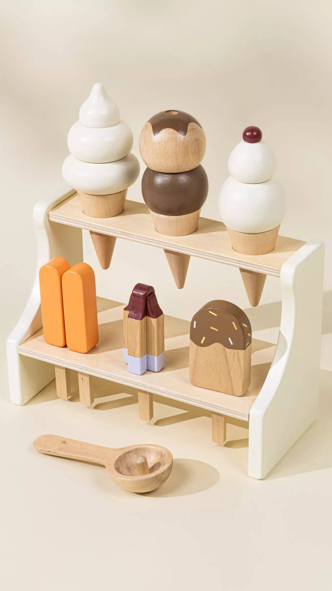 Angled view of the Wooden Ice Cream Stand playset, showing a complete set of ice cream cones, ice pops, and a spoon, designed to encourage children’s creativity and hand-eye coordination through pretend play.