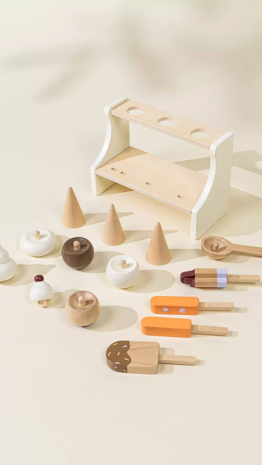Complete display of Wooden Ice Cream Stand playset with three ice cream cones, three ice pops, and a spoon laid out, encouraging children to engage in creative, hands-on play while developing essential skills.
