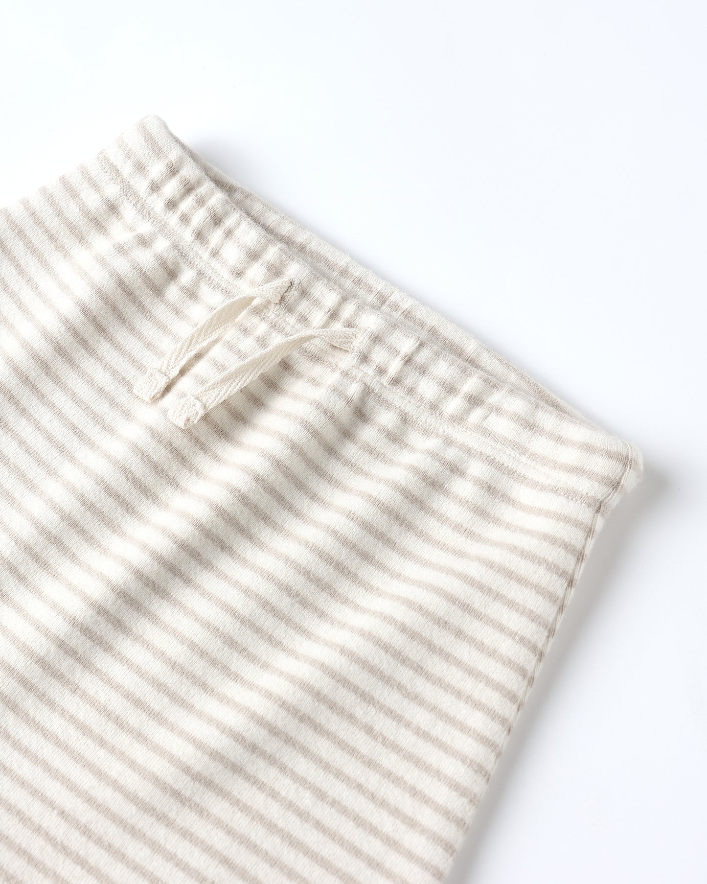 Close-up of Quincy Mae Drawstring Pant showing soft organic cotton knit, oat micro stripe pattern, and functional drawstring detail.