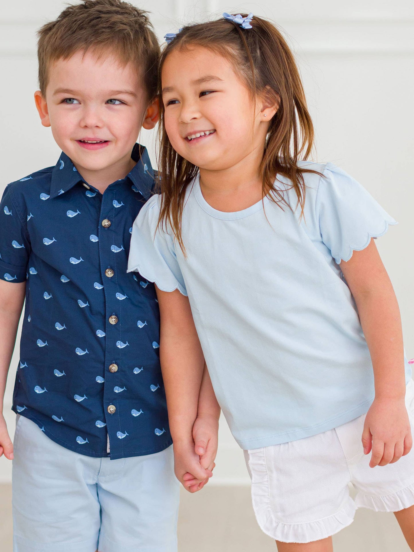 Side view of baby girl in blue shirt and shorts, perfect spring outfit for play and photos