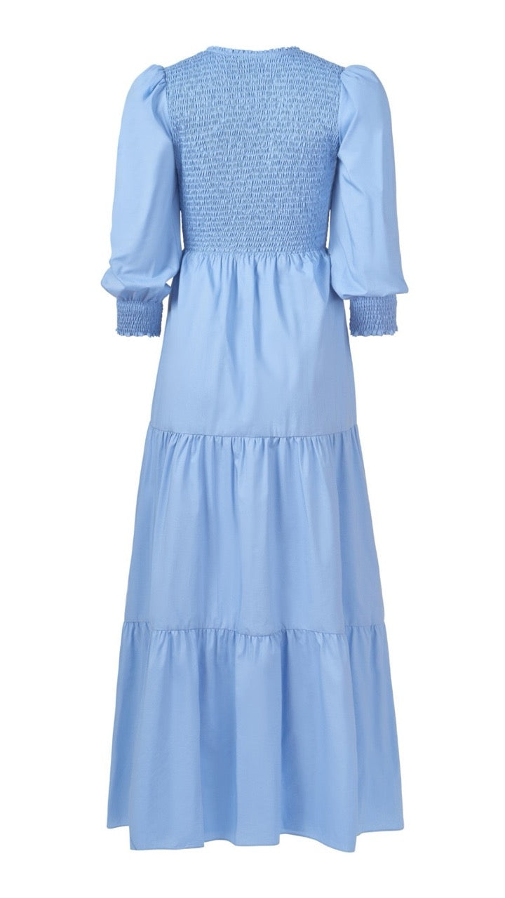 Back view flat lay of chambray Bridgette Dress, highlighting smocked cuff and soft flowing silhouette.
