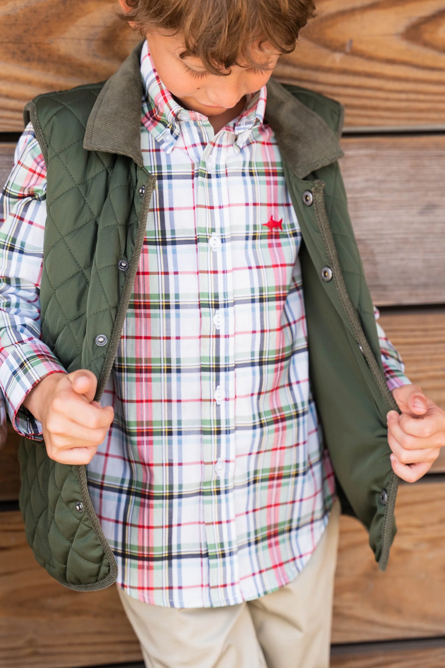 Young boy wearing Carter Oxford Shirt layered with vest, showing stylish layering, warmth, and classic creme plaid design.