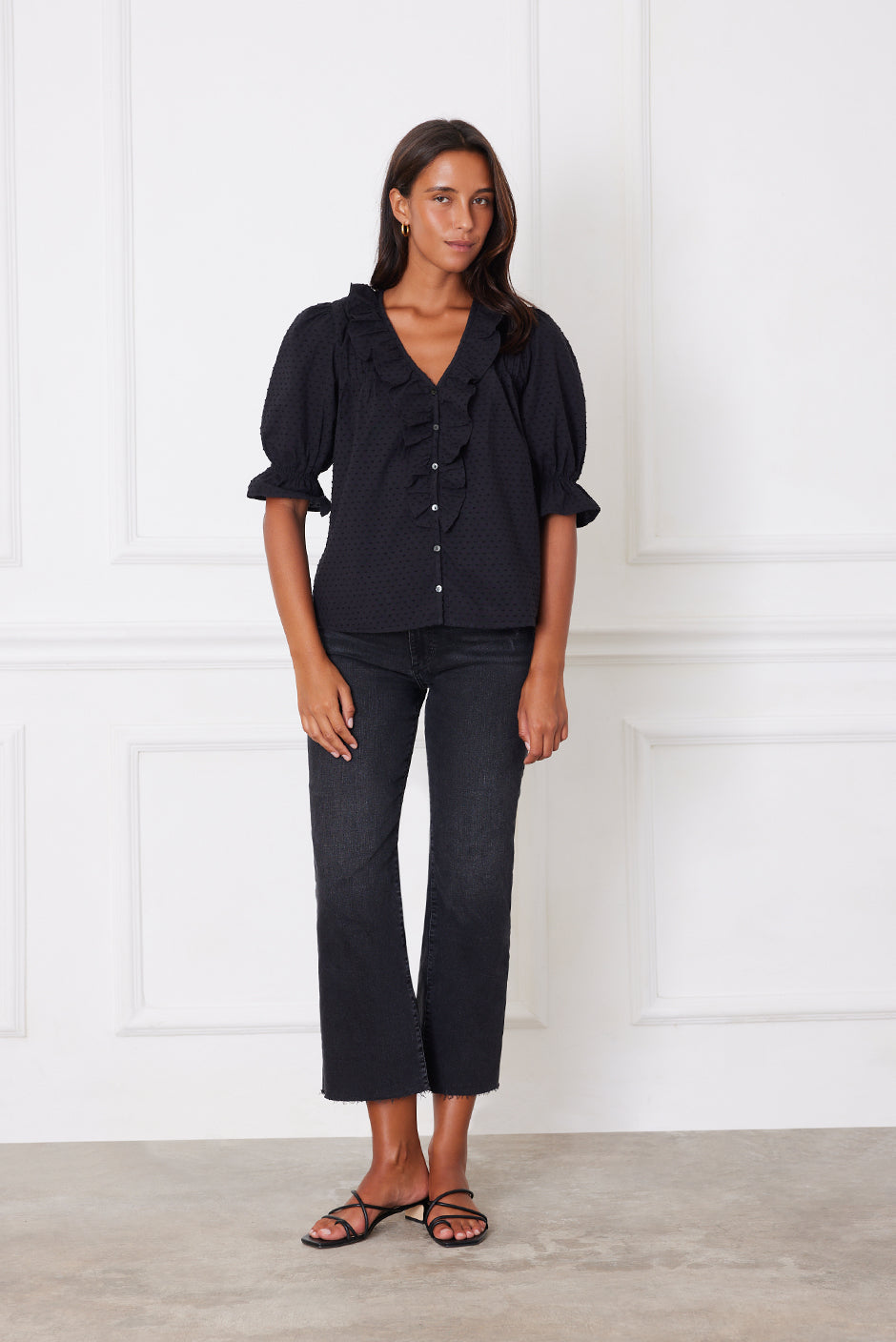 Front studio view of the Chloe Shirt in white clip dot fabric, showcasing ruffle neckline, pin-tuck details, and real shell buttons.