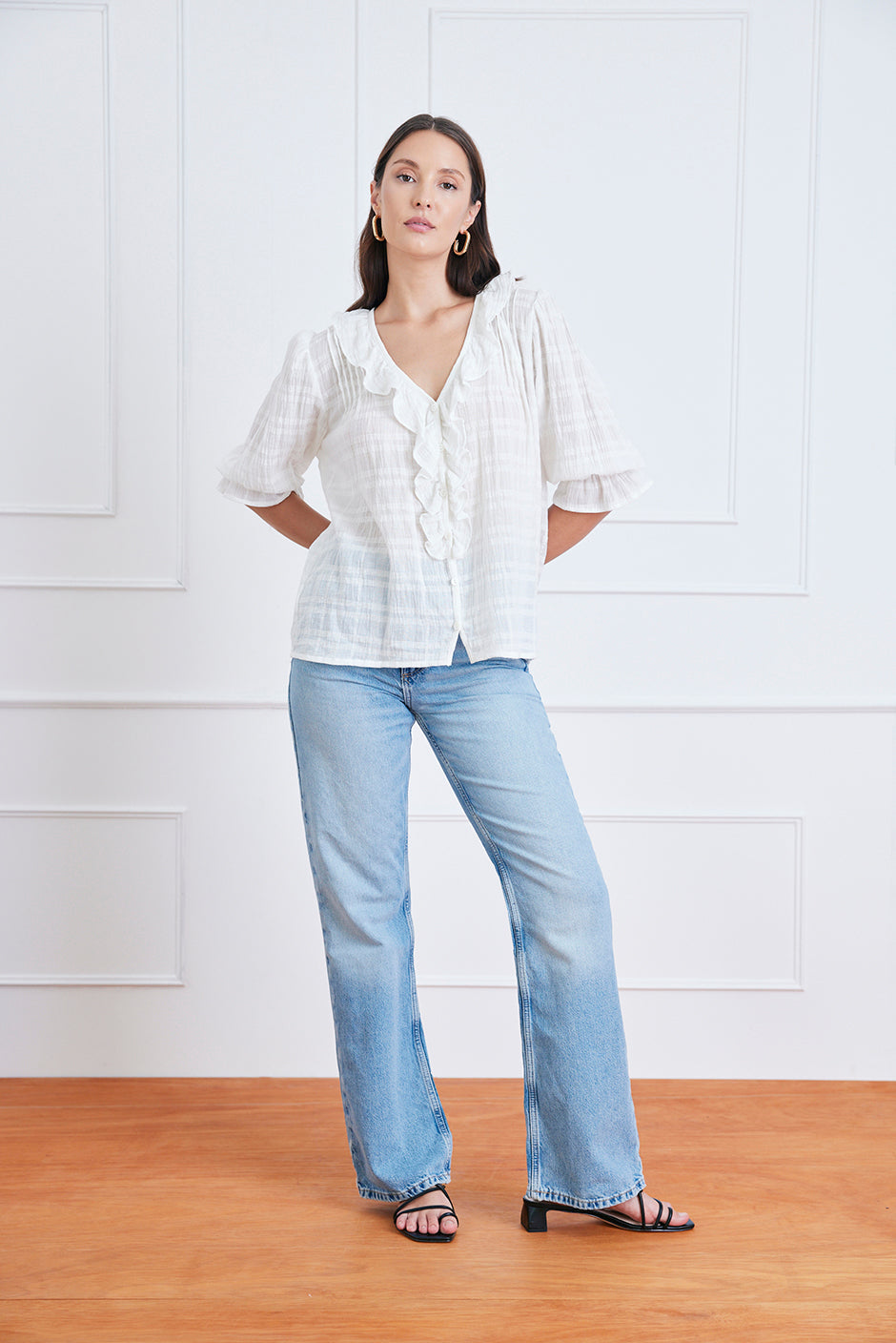 Front studio view of the Chloe Shirt in soft plaid cotton, showcasing ruffle neckline, pin-tuck details, and real shell buttons.