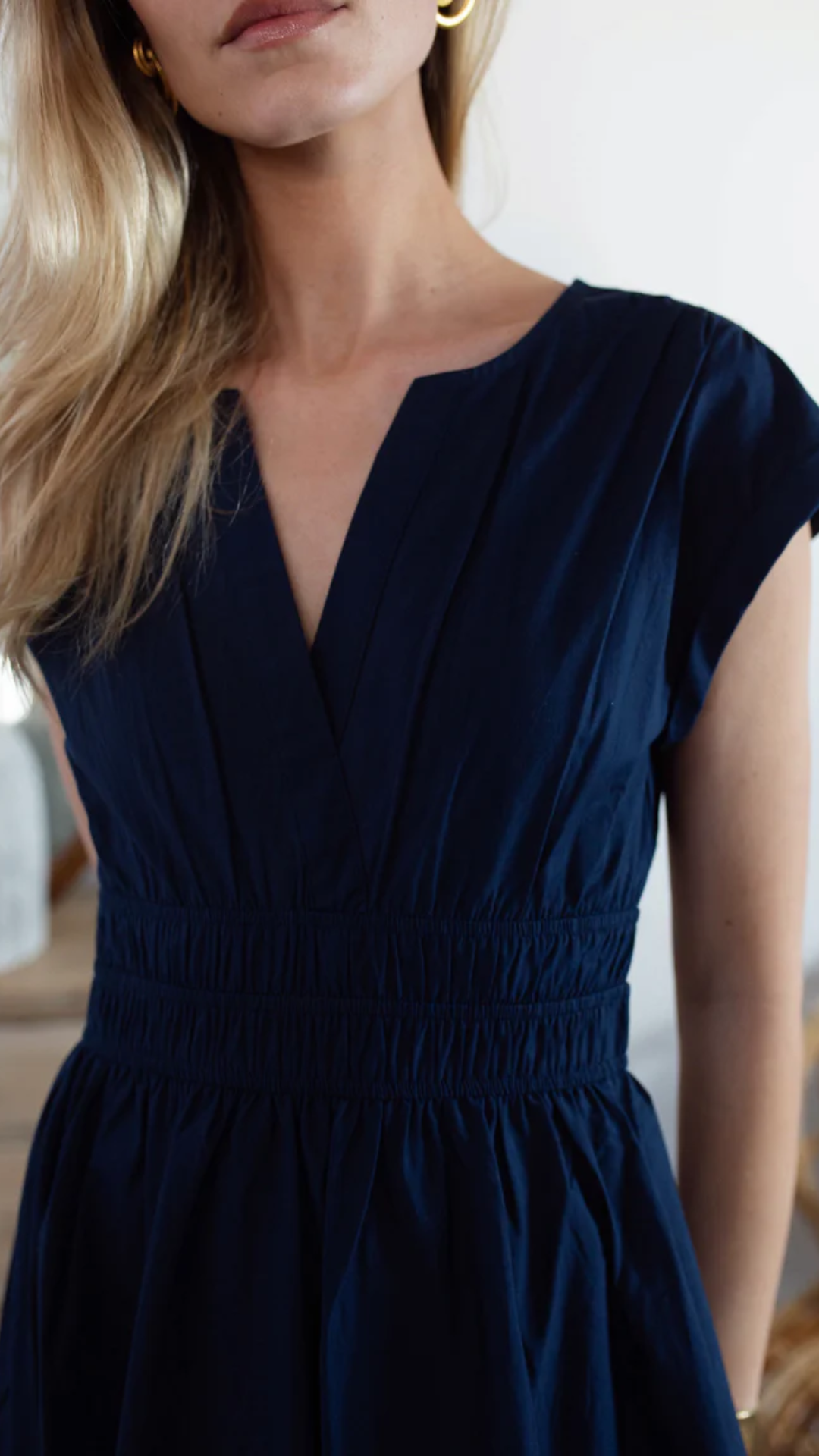 Waist and skirt detail of the Marea Clara Dress on a model, highlighting the elasticated waist and fluid drape of the fabric.