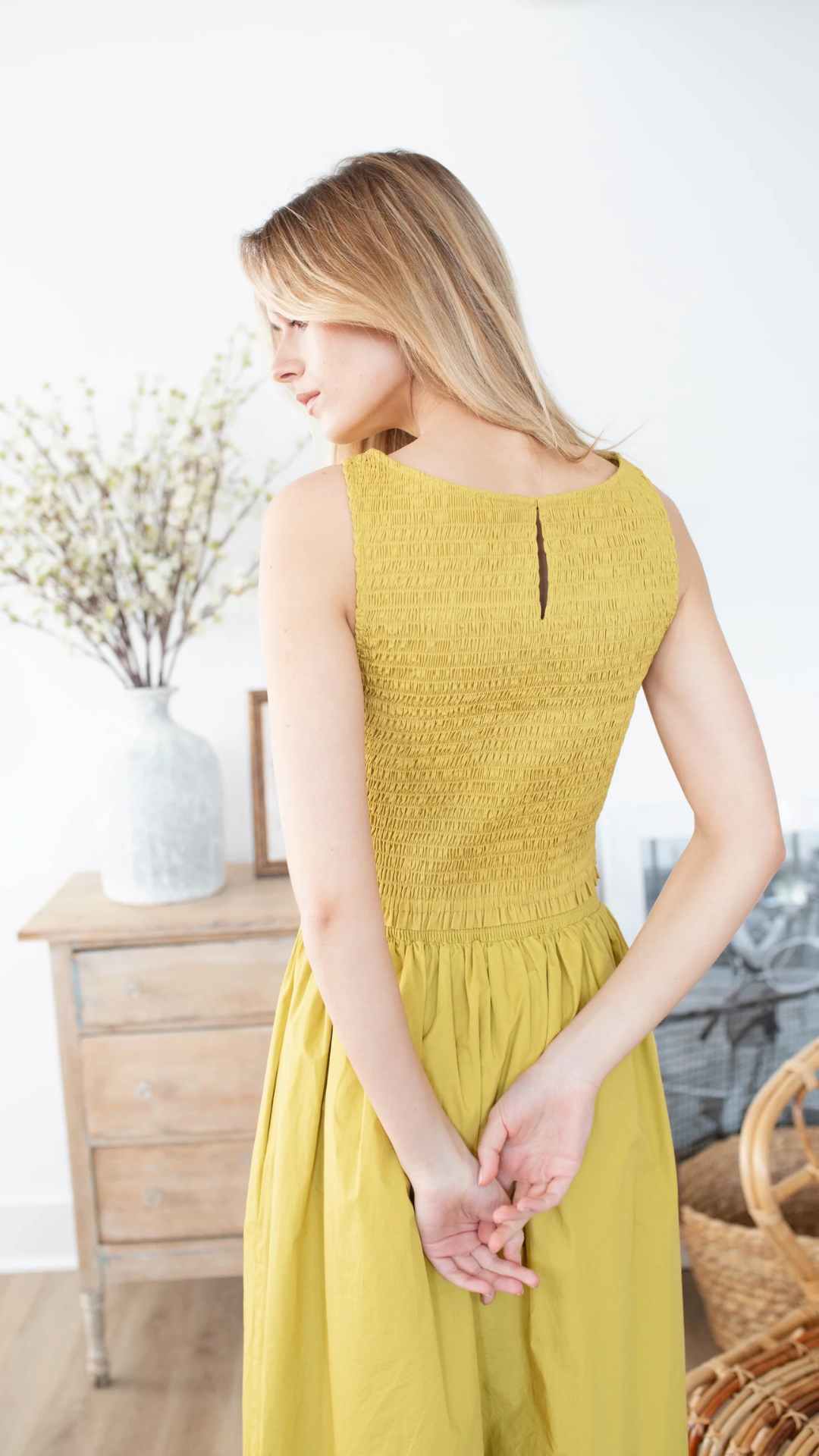 Back view of the Charlotte Top in studio, featuring the elegant keyhole button closure and soft smocked fit.