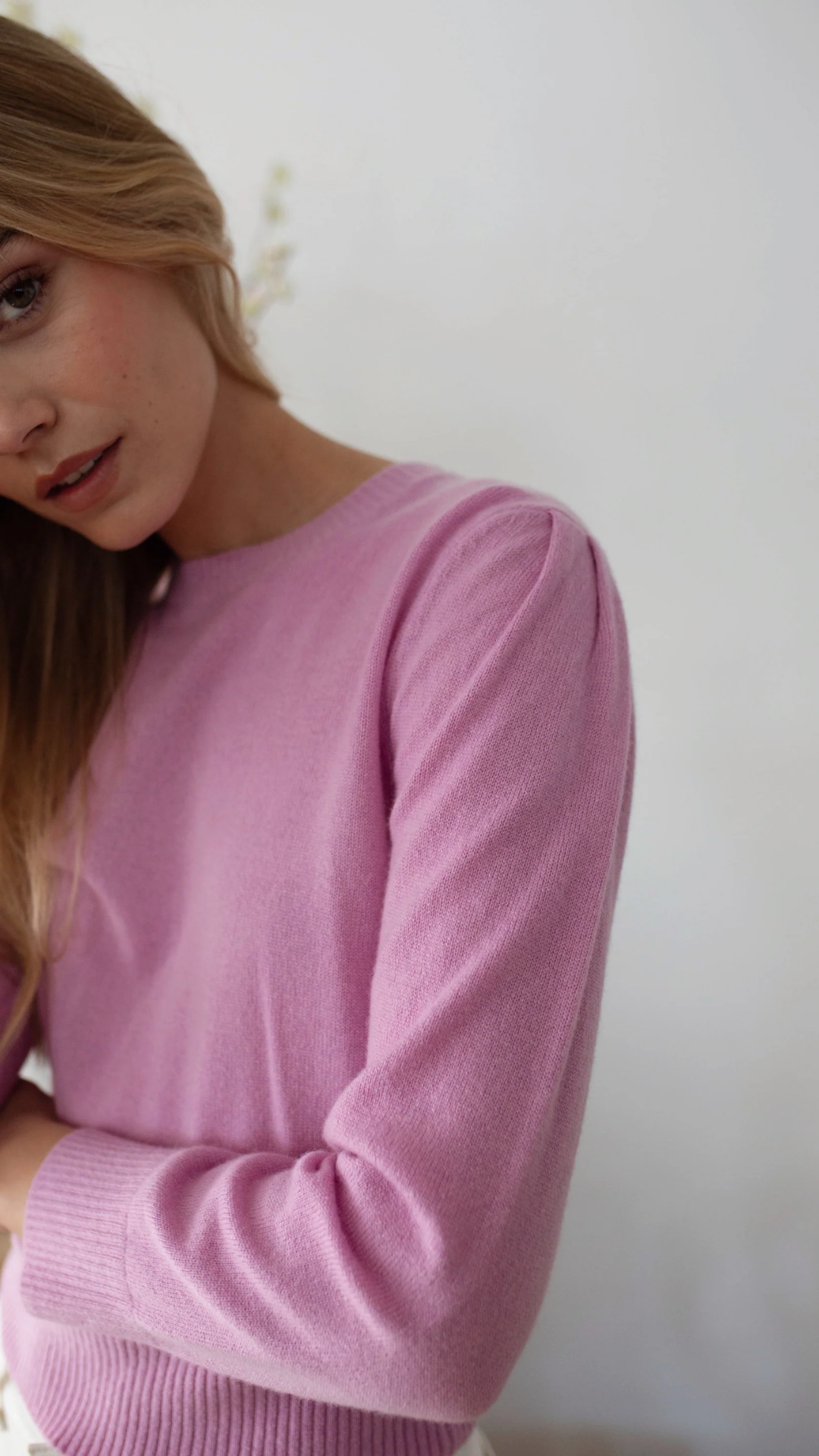 Side view of the lightweight cashmere crewneck sweater, demonstrating its seamless, classic silhouette.