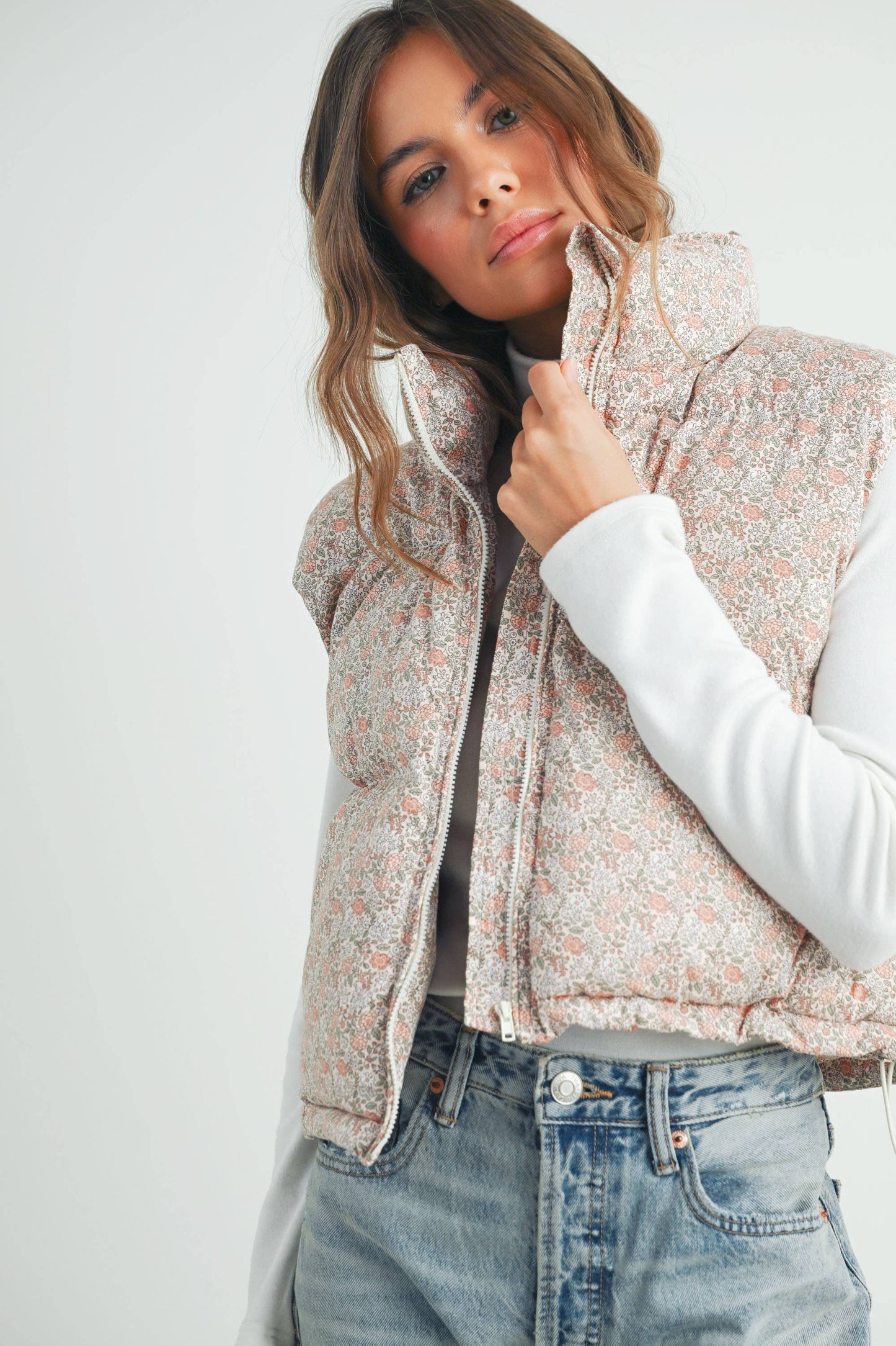 Close-up of model wearing the Floral High Neck Puffer Vest, focusing on high collar, shoulder structure, and subtle floral print