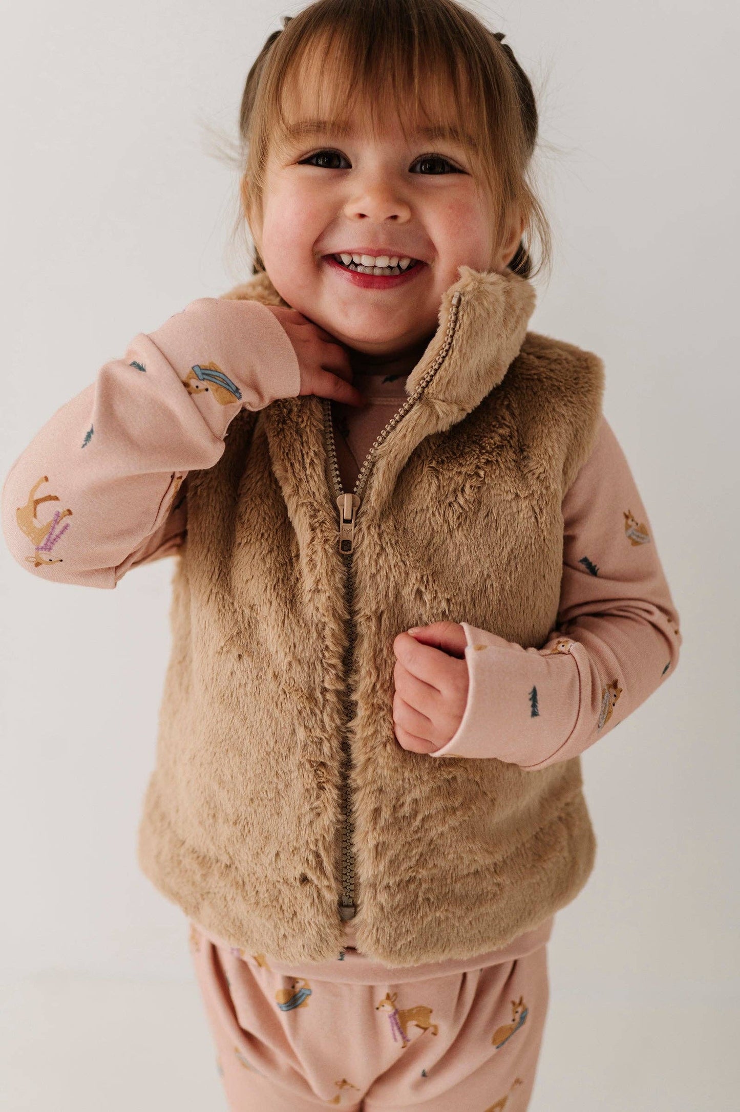 Close-up of faux fur vest on child, highlighting plush texture, high-quality finish, and cozy warmth.