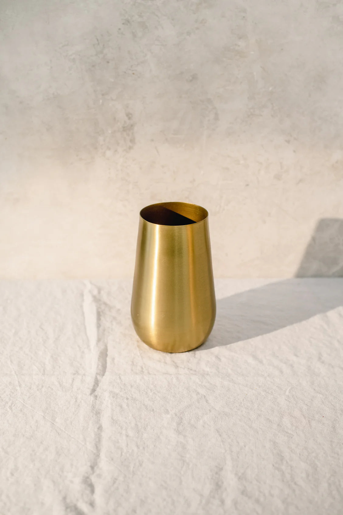 Gold vase by Gather Intentional Living – designed by Kayty Helgersen, a Connecticut local and hospitality specialist, perfect for adding warmth and elegance to your home décor.