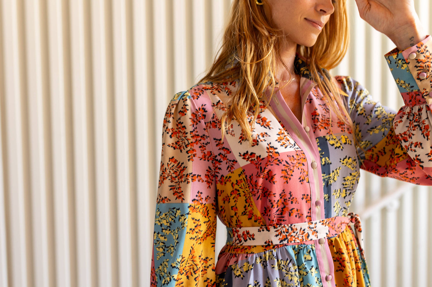 Detailed view of The Jules Dress top, highlighting the button-up placket, collar, and floral patchwork fabric.