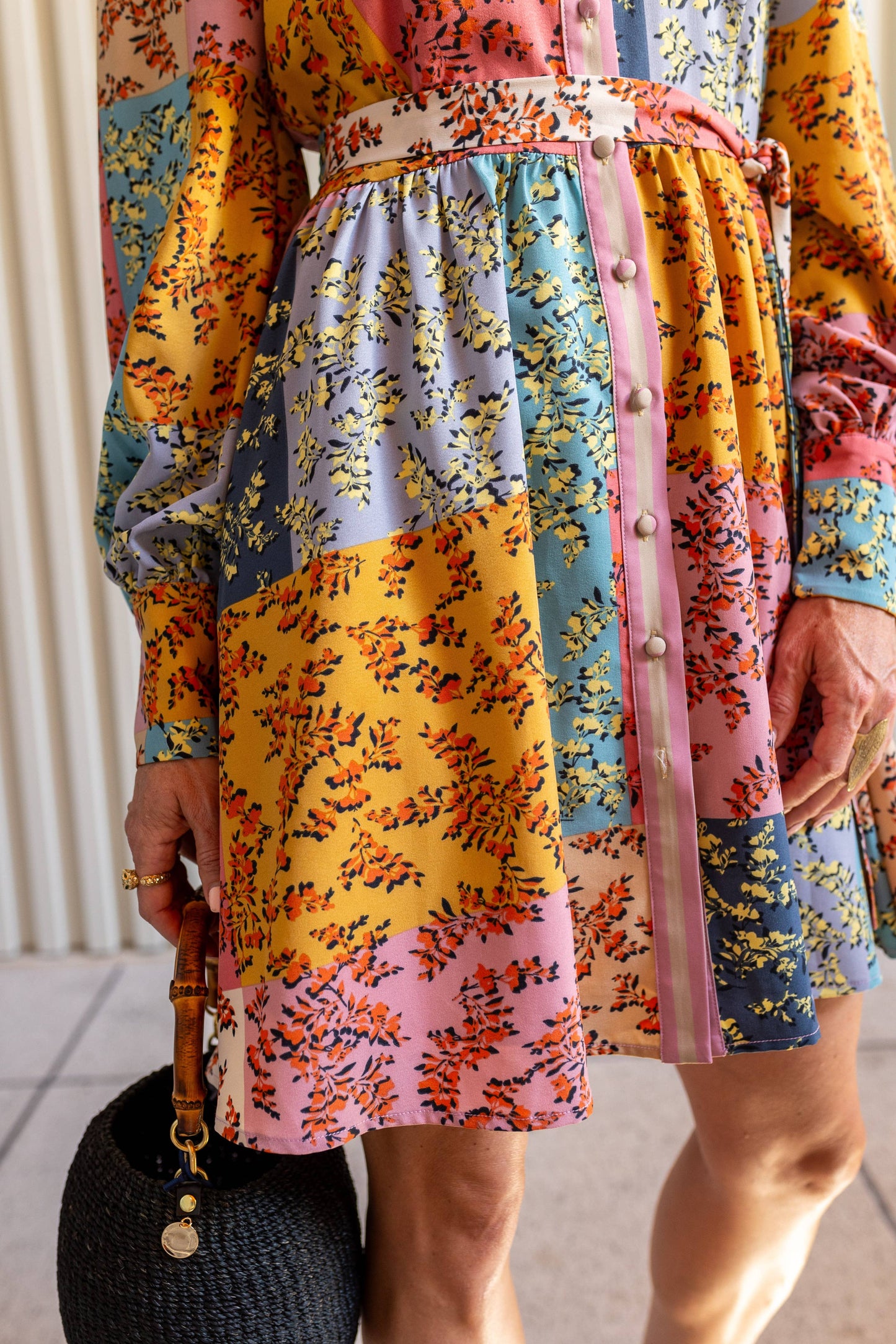 Close-up of The Jules Dress skirt showing floral pattern and flowy mid-thigh hemline detail.