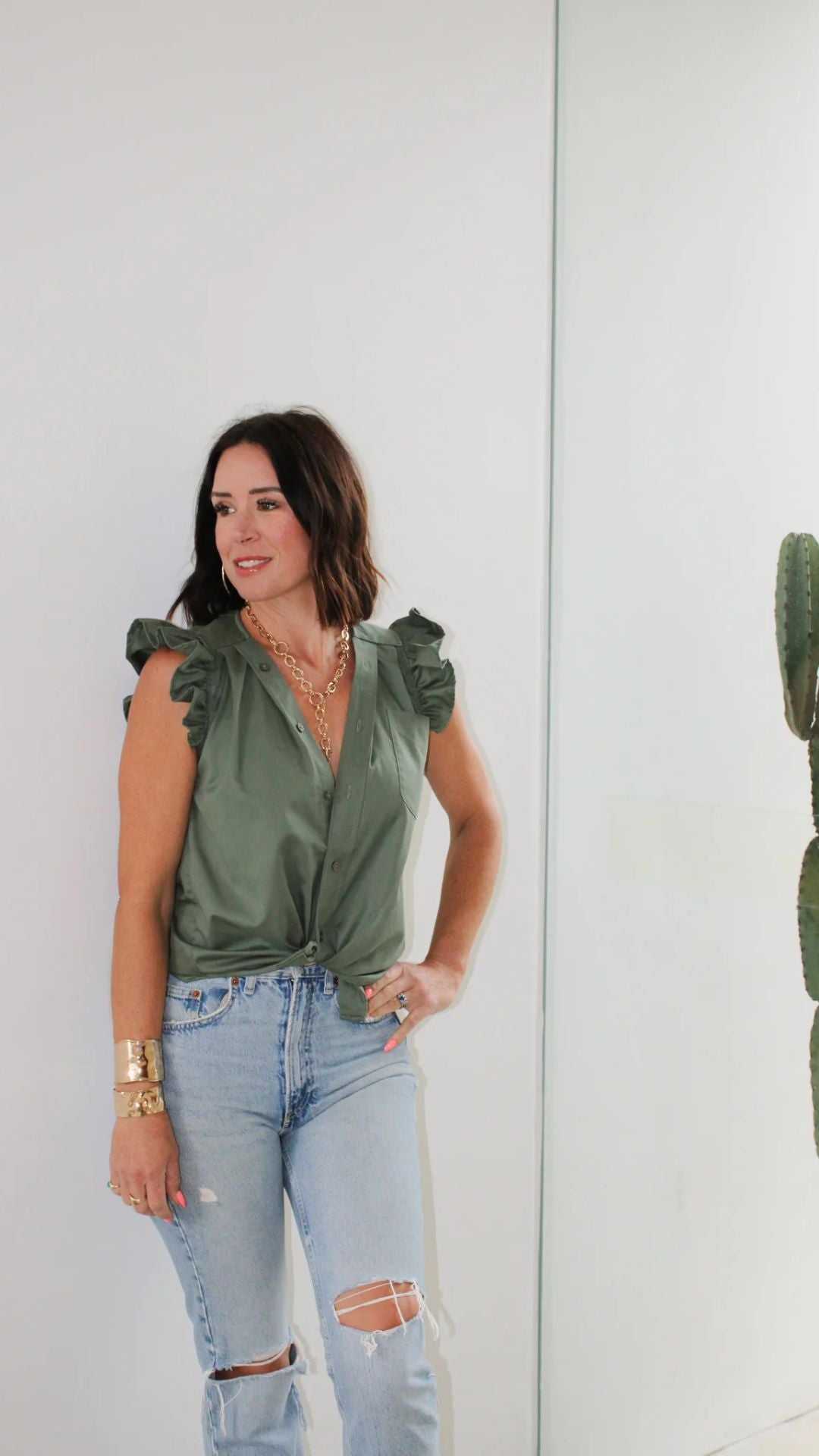 Close-up side view of the Olivia in Olive worn by designer Kate, highlighting sleeve detail and relaxed fit.