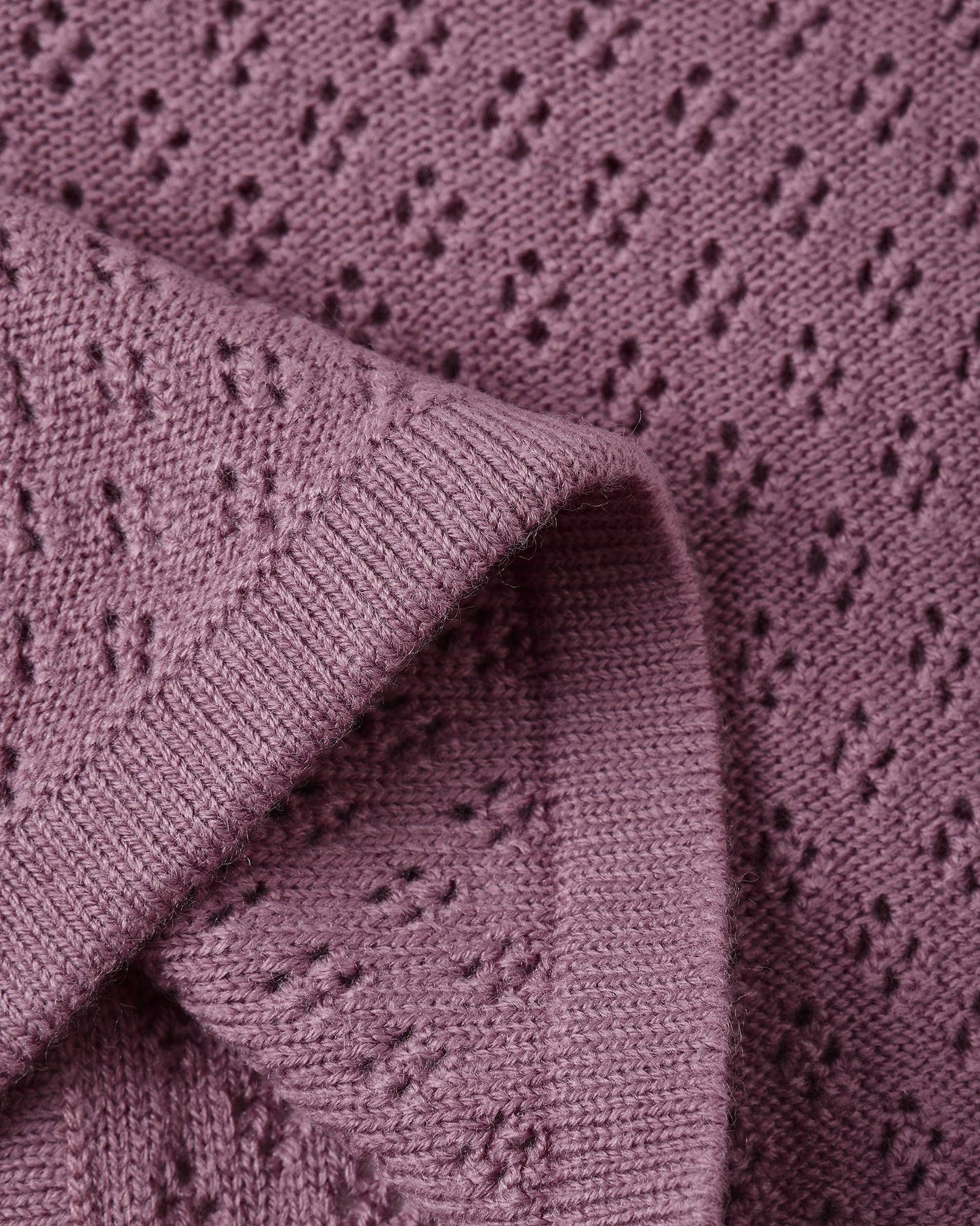 Close-up of button closure and knit texture on the Mulberry Knit Cardigan by Quincy Mae.