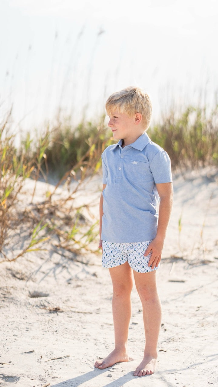 Young boy wearing The Marco Boys Polo by Saltwater Boys at the beach, showcasing its casual yet polished look in a natural, coastal setting
