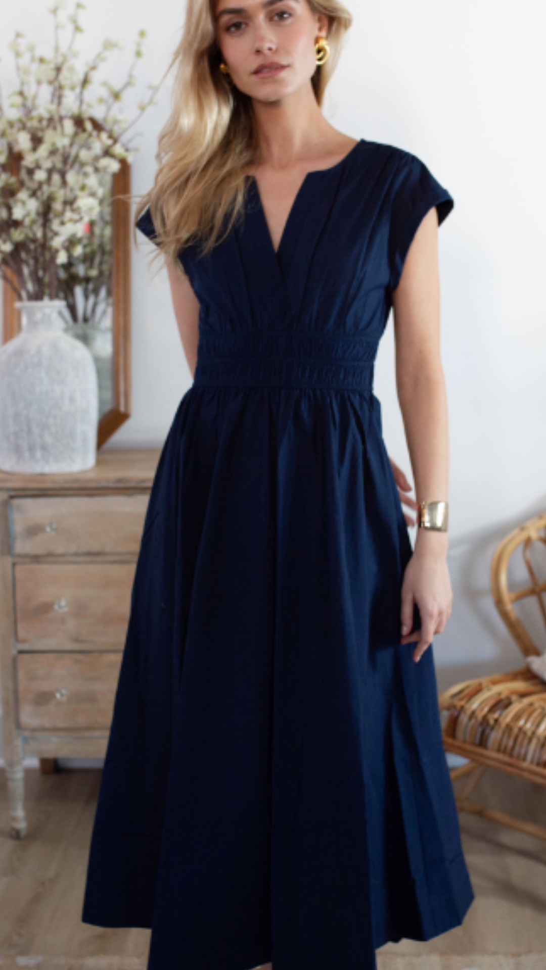 Studio full-length image of a model wearing the Marea Clara Dress, displaying its effortless and versatile midi-length fit.
