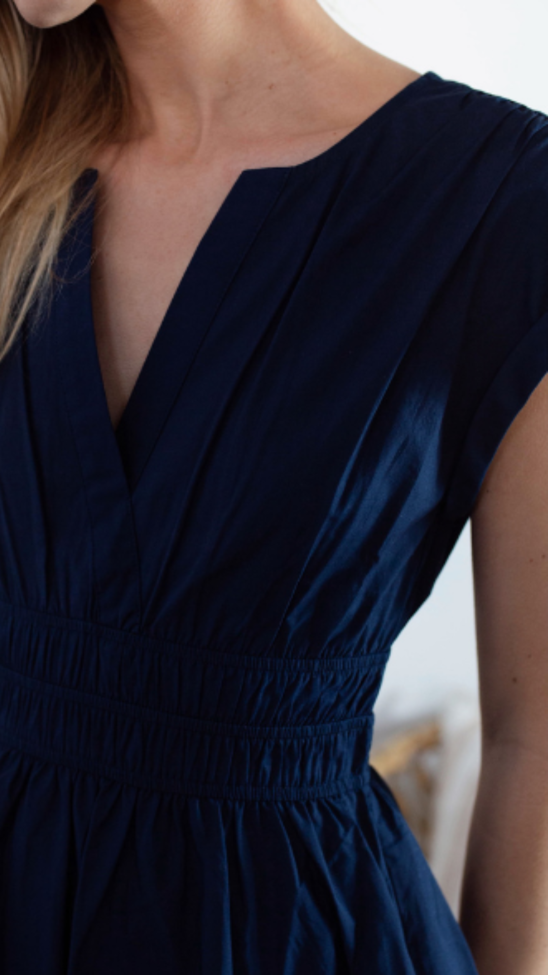 Close-up of the Marea Clara Dress on a model, focusing on the sophisticated zen neckline and flattering fit.