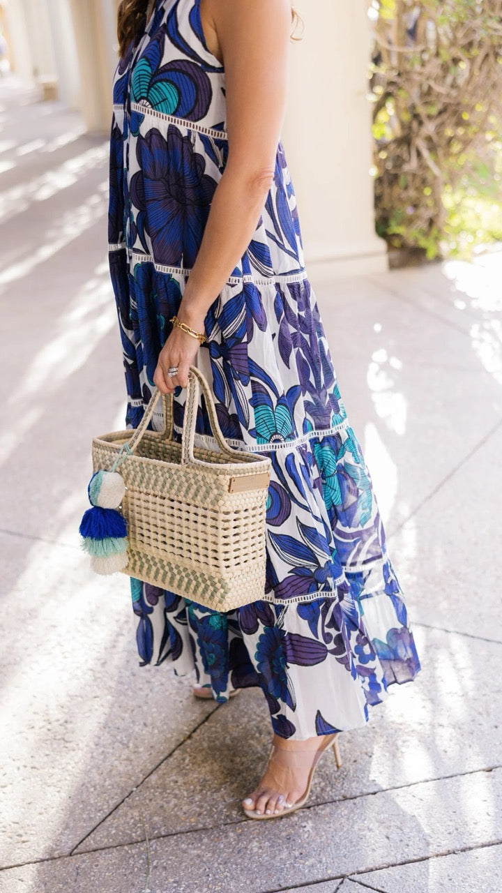 Side view highlighting the tote's compact size and intricate weaving.
