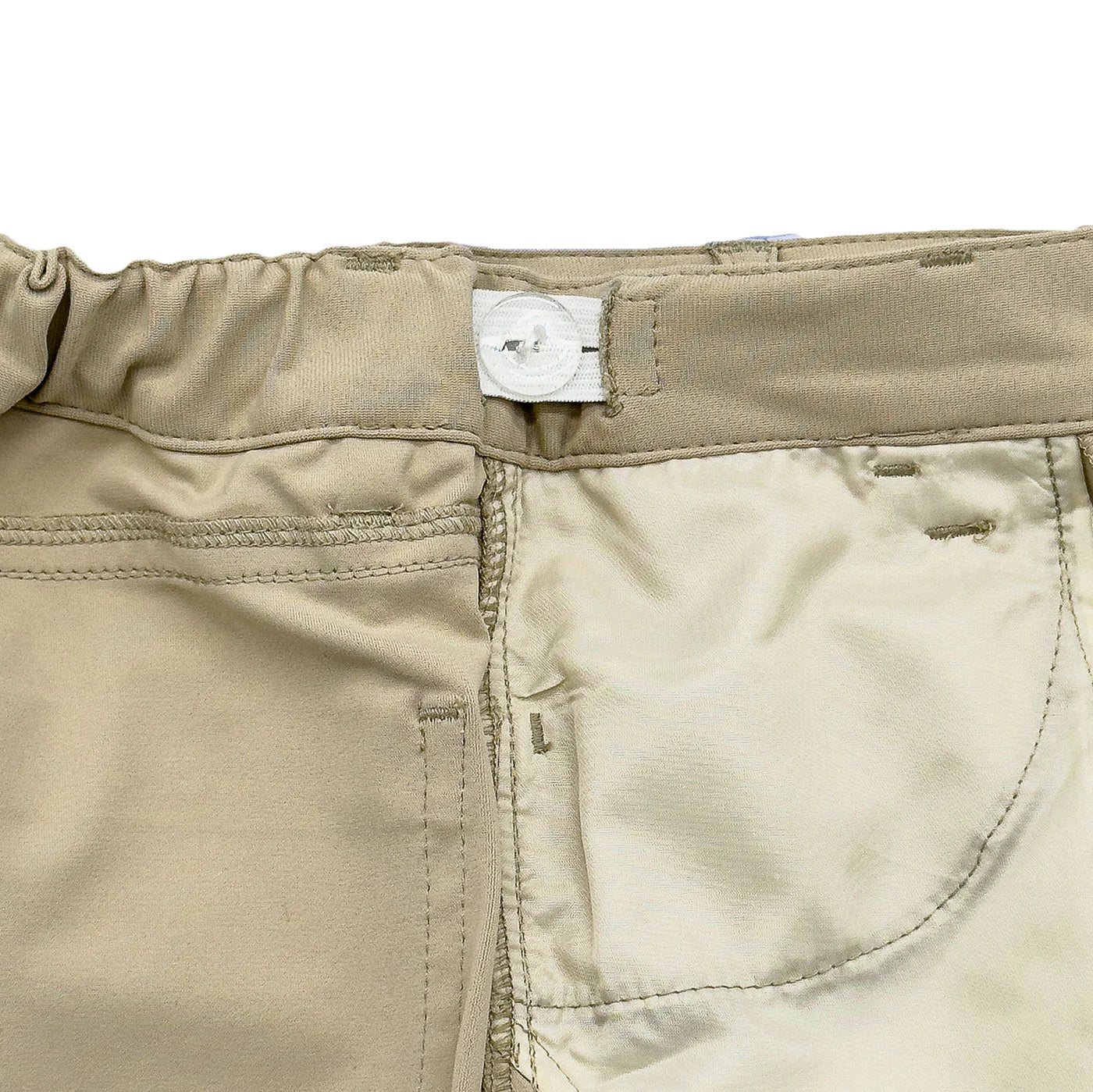 Close-up of built-in growth tabs on Par Performance Pants, showing adjustable waist for long-lasting fit and comfort.