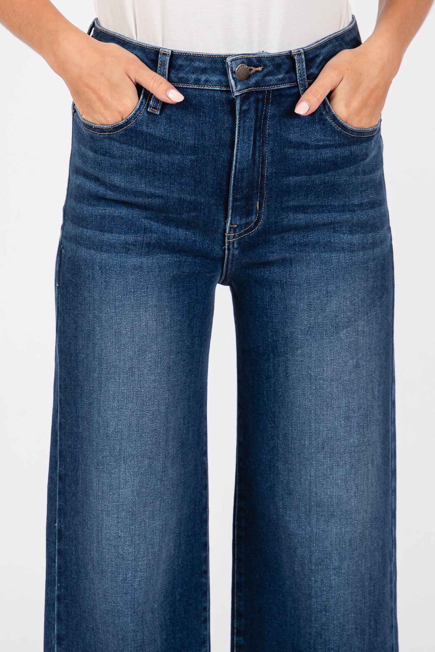Detailed close-up of Pipa High Rise Superwide Jeans front fly with hands in pockets, showing denim texture, stitching, and waistband structure.