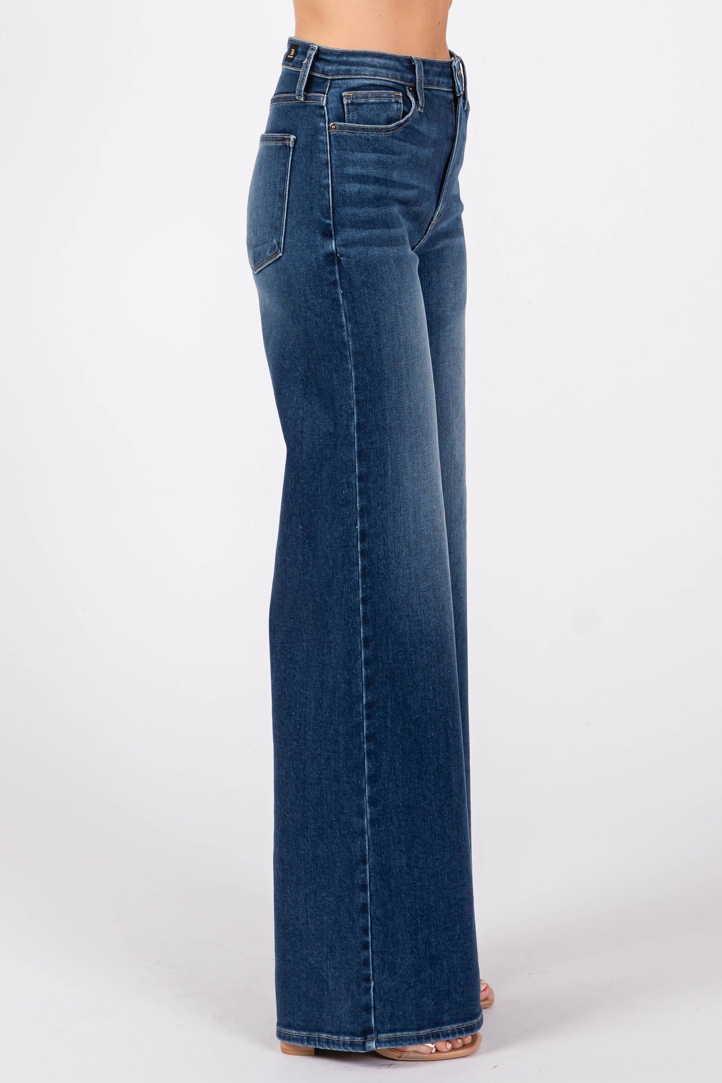 Side profile of model wearing Pipa High Rise Superwide Jeans, highlighting the dramatic wide leg silhouette and flattering high rise fit.