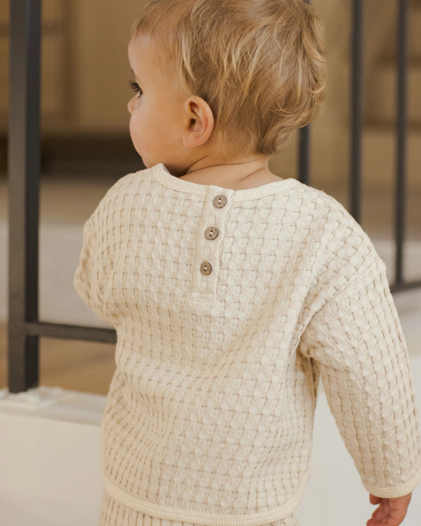 Close-up of Quincy Mae Flynn Set top, showing back button detail in natural chunky waffle knit fabric.