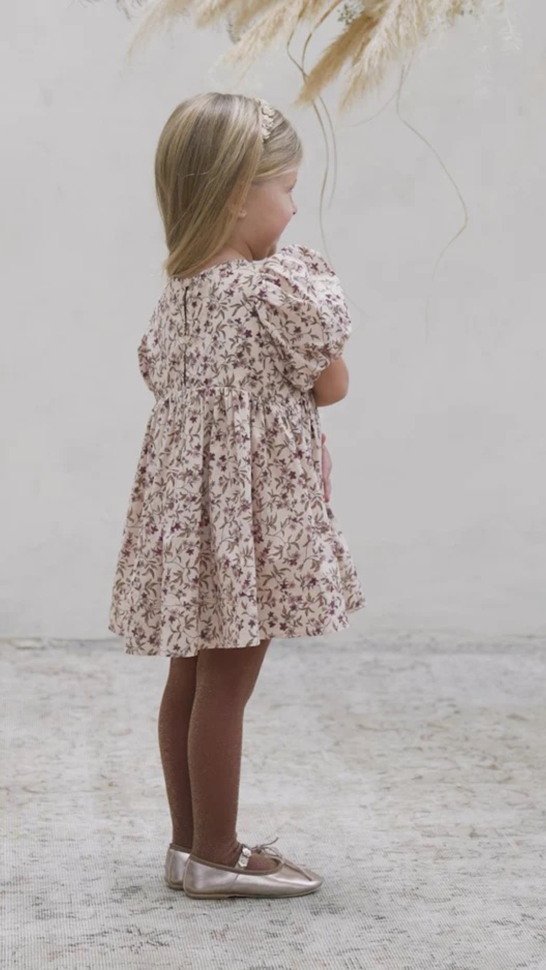 Back view of toddler in Noralee Shimmer Tights in Golden & Fig, highlighting the flattering fit and shimmering texture.