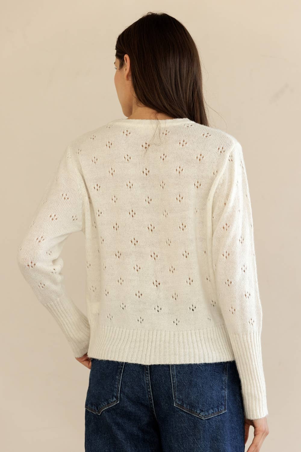 Back view of Storia Ribbed Knit Button-Down Cardigan showing cropped hem and soft knit details