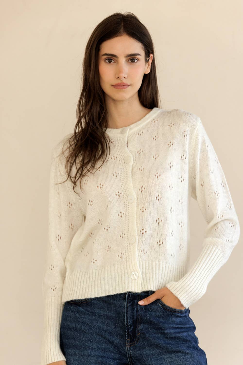Woman wearing Storia Ribbed Knit Button-Down Cardigan with denim, hand in pocket, front view in studio