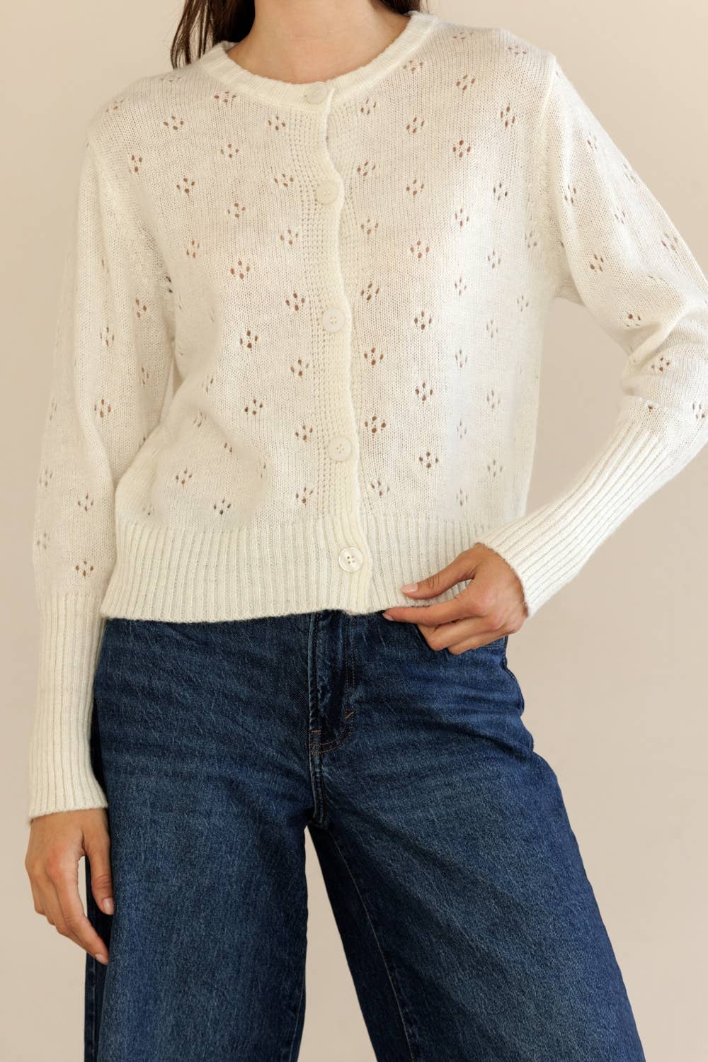 Woman modeling Storia Ribbed Knit Cardigan from the front with hand on hip, highlighting button details