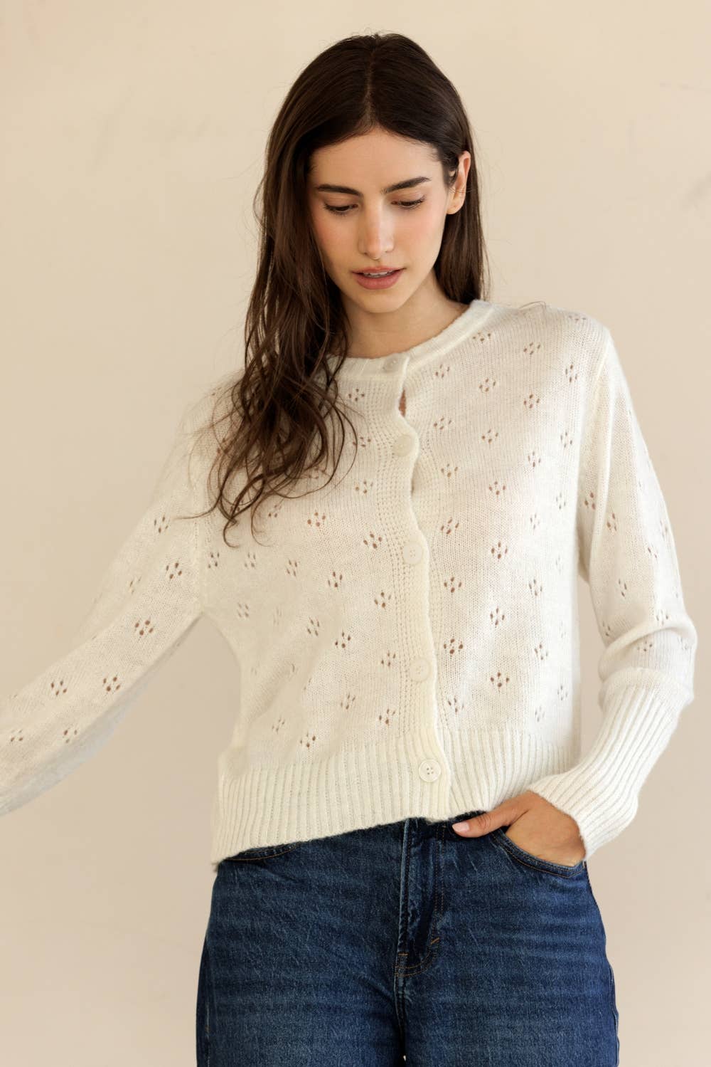 Model in motion wearing lightweight Storia Ribbed Knit Cardigan, showing relaxed fit and feminine silhouette