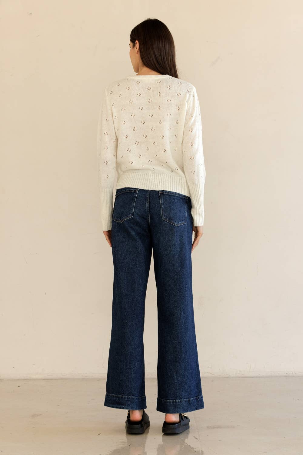 Full outfit back view of Storia Cropped Ribbed Cardigan paired with denim, showing relaxed silhouette