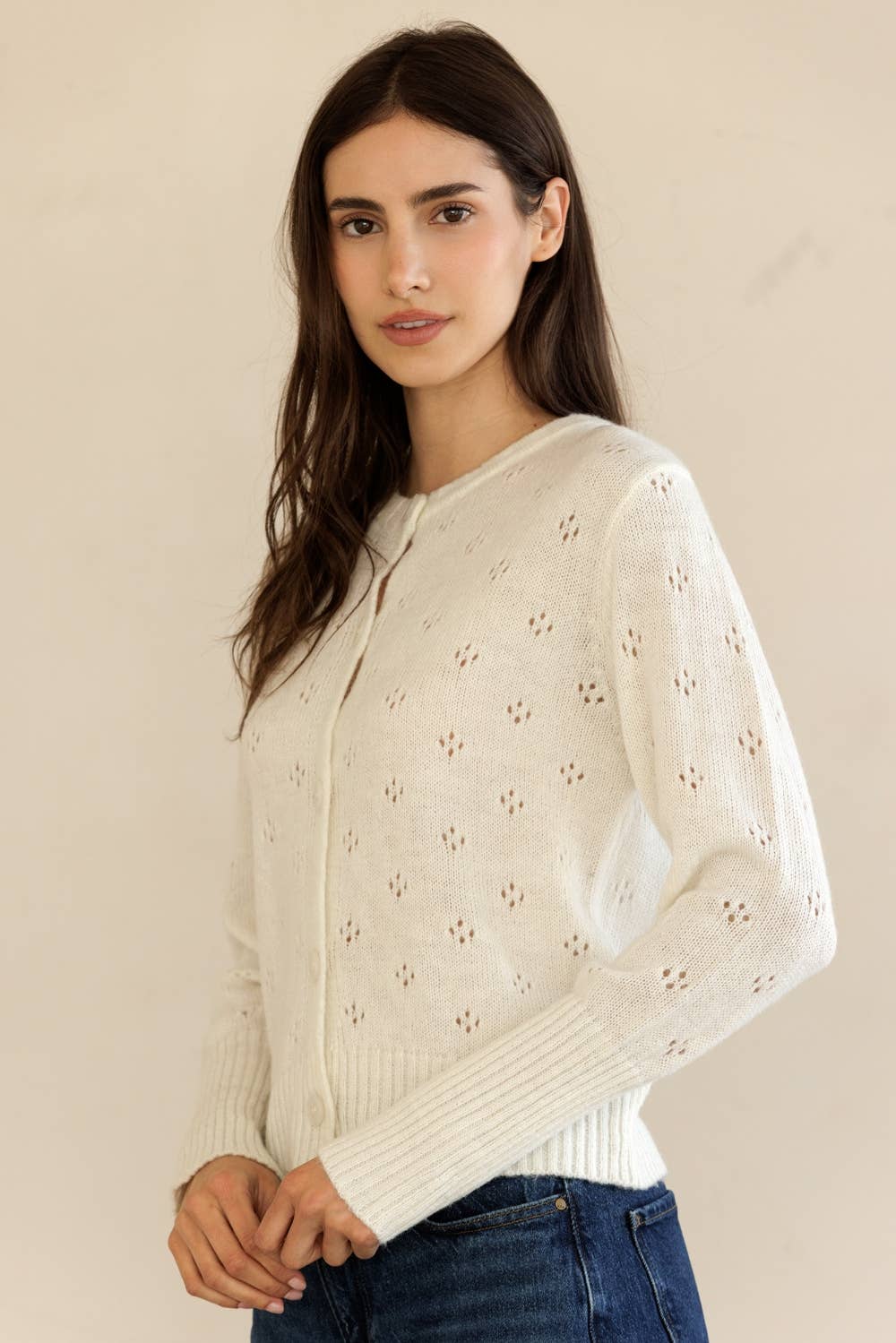 Side profile of Storia Button-Down Knit Cardigan with breathable openwork pattern and long sleeves