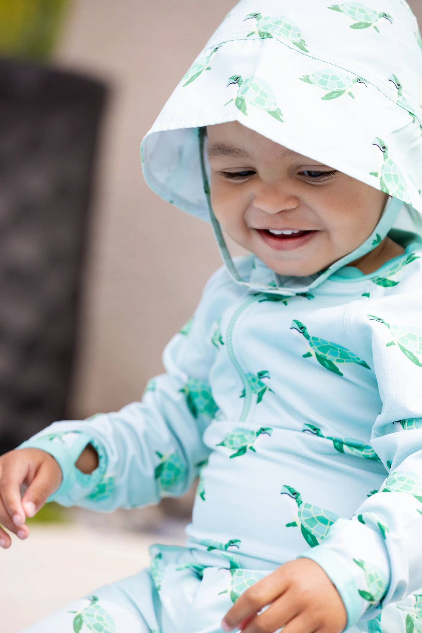 Front view of child in Sea Turtles sun hat, showing full bucket hat brim and fun turtle pattern