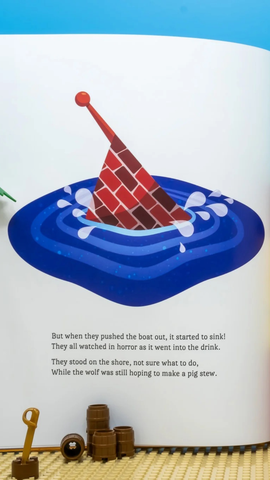 Charming scene where the pirate pigs test their straw, brick, and wood ships in “The Three Pirate Pigs” children’s book.