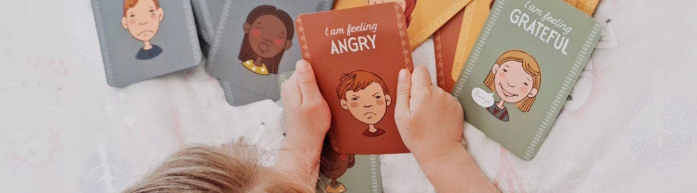 Child engaging with Emotions Cards from Grace & Haven’s Mindfulness for Kids Holiday Gift Guide, learning emotional awareness and self-regulation through play