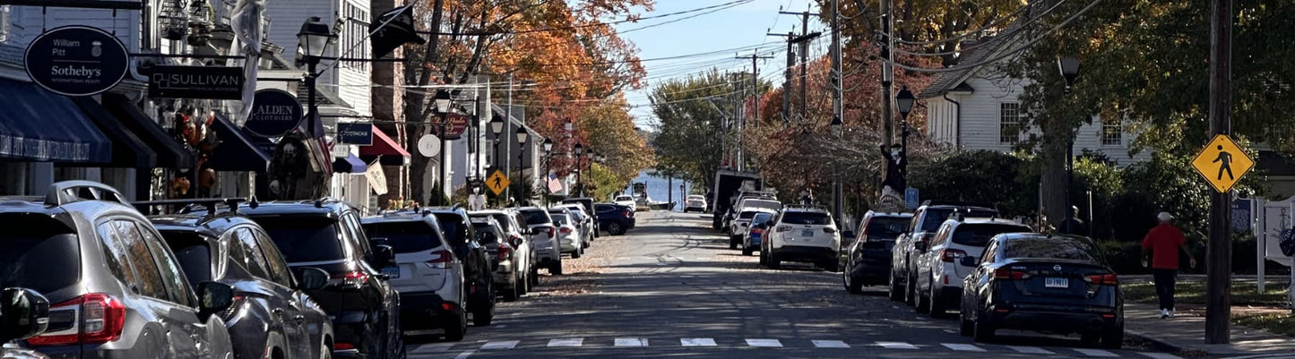 Main Street Essex CT in spring with storefronts and daffodils — the #1 small town in New England