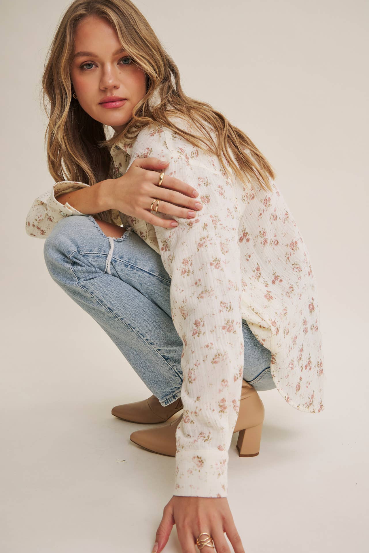Soft Breeze Floral Cotton Gauze Relaxed Fit Shirt in cream with pink floral pattern, worn by a woman crouching in light blue