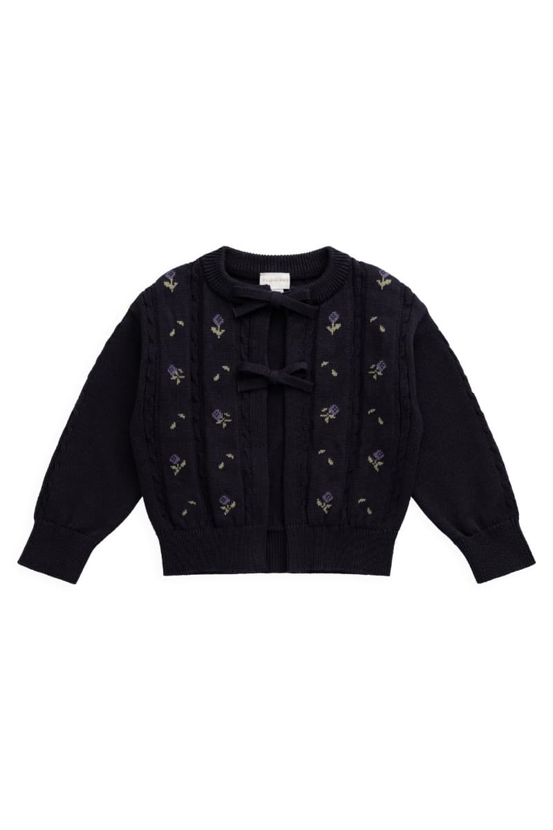 A dark purple knit cardigan sweater with floral detail and front bows by Jamie Kay, displayed flat against a white background. Avialable at Grace & Haven in Essex, CT or online at graceandhaven.co