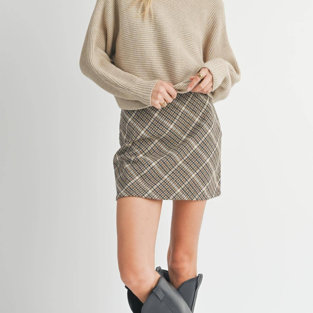 
                      
                        Front-facing shot of the Anya Turtleneck Sweater styled with a skirt and tall boots, perfect for an elevated yet comfortable look.
                      
                    