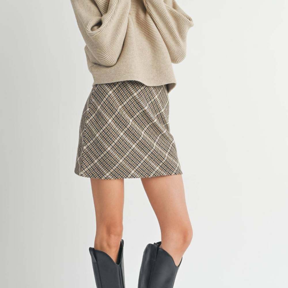 
                      
                        Model wearing the Anya Turtleneck Dolman Sleeve Sweater with a short skirt and tall boots, showcasing a chic fall outfit.
                      
                    