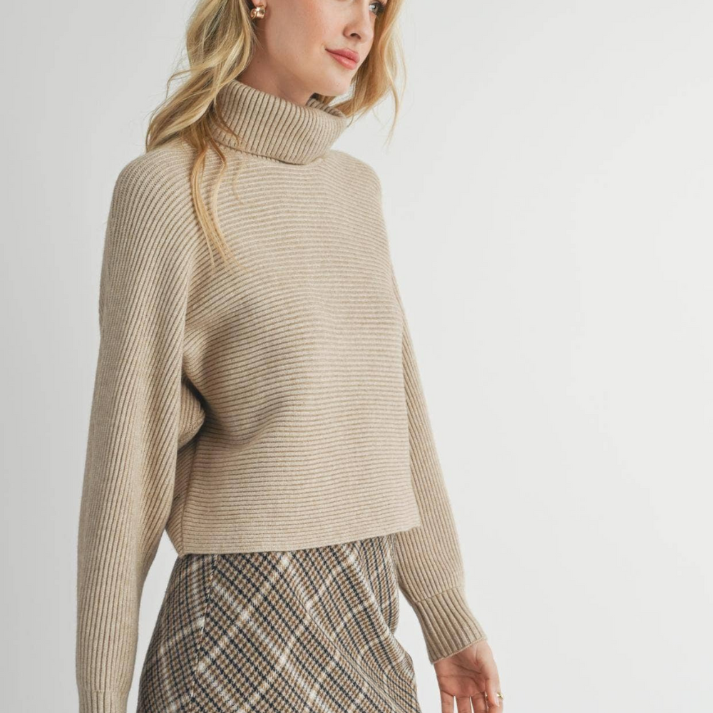 
                      
                        Model showing the Anya Turtleneck Sweater’s relaxed silhouette, perfect for comfortable all-day wear, indoors or out.
                      
                    