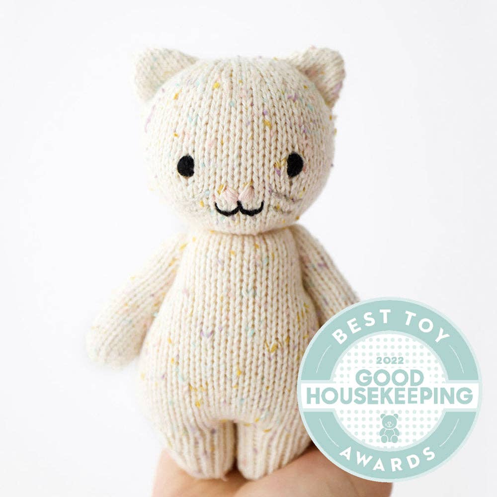 
                      
                        Front view of the Baby Kitten plush toy from Cuddle & Kind, featuring a soft, hand-knitted design in light pink and cream colors. This adorable stuffed animal is made with organic cotton and is perfect for babies, offering comfort and companionship. The Baby Kitten's sweet face and gentle textures make it an ideal gift for little ones. As part of Cuddle & Kind's mission, each purchase supports children in need. A thoughtful, cuddly addition to any nursery or playtime collection.
                      
                    