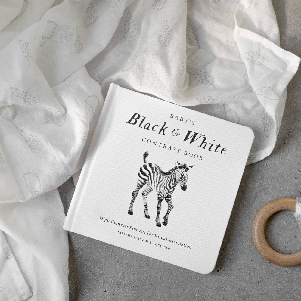 
                      
                        Flat lay of Baby's Black and White Contrast Book by Tabitha Paige, featuring high-contrast black and white illustrations to stimulate early visual development. A perfect first book for newborns, available at Grace & Haven in Essex, CT.
                      
                    