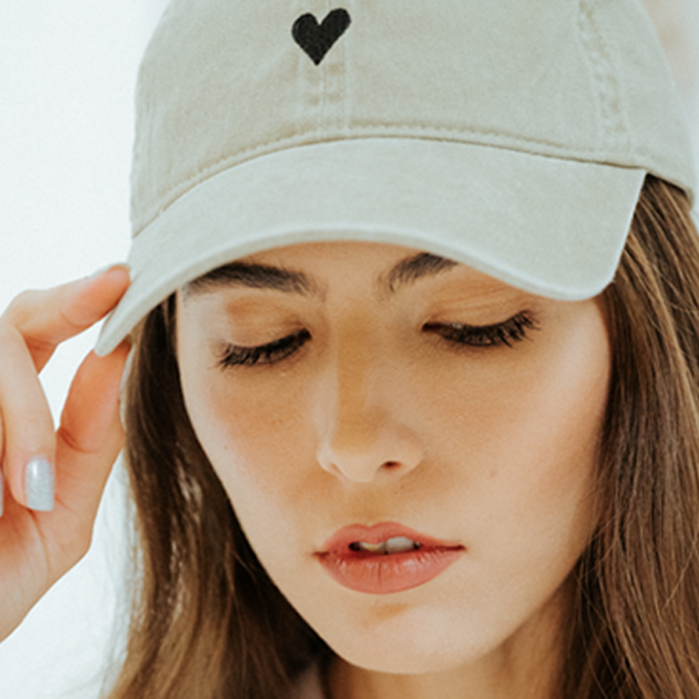 Close-up of the adjustable strap on the Beige Heart Hat in light beige.