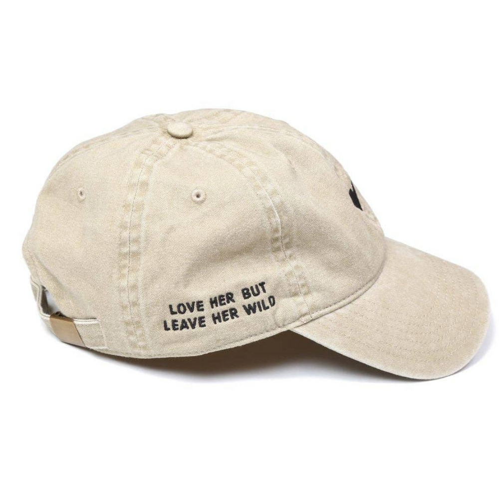 
                      
                        Close-up of the embroidered text ‘Love her but leave her wild’ on the Beige Heart Hat.
                      
                    